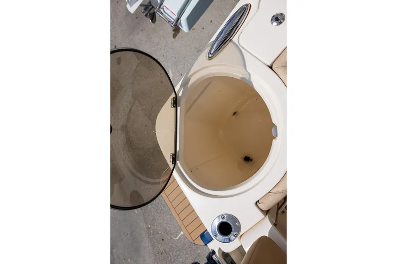 Slide: The Image of Open storage compartment on 2018 Scout 275 Dorado boat, featuring beige interior. - 10