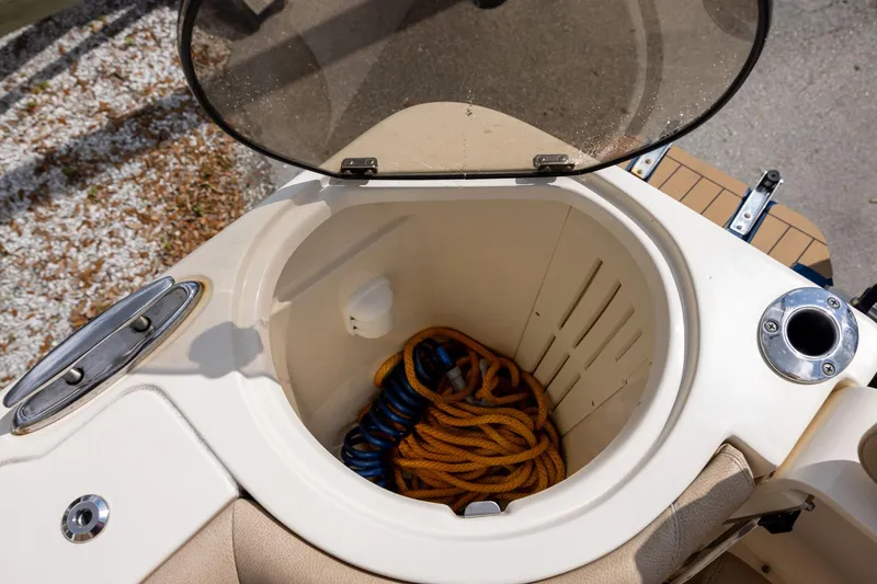 Slide: The Image of Storage compartment on 2018 Scout 275 Dorado boat with coiled rope inside. - 11