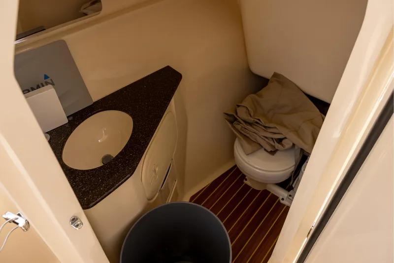 Slide: The Image of Interior of 2018 Scout 275 Dorado boat bathroom with sink and toilet. - 14