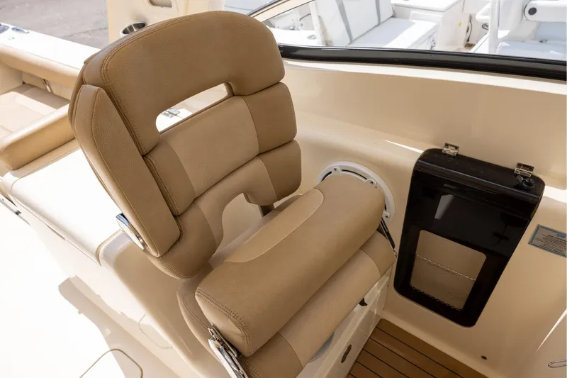 Slide: The Image of 2018 Scout 275 Dorado boat seat with tan upholstery and sleek design. - 15