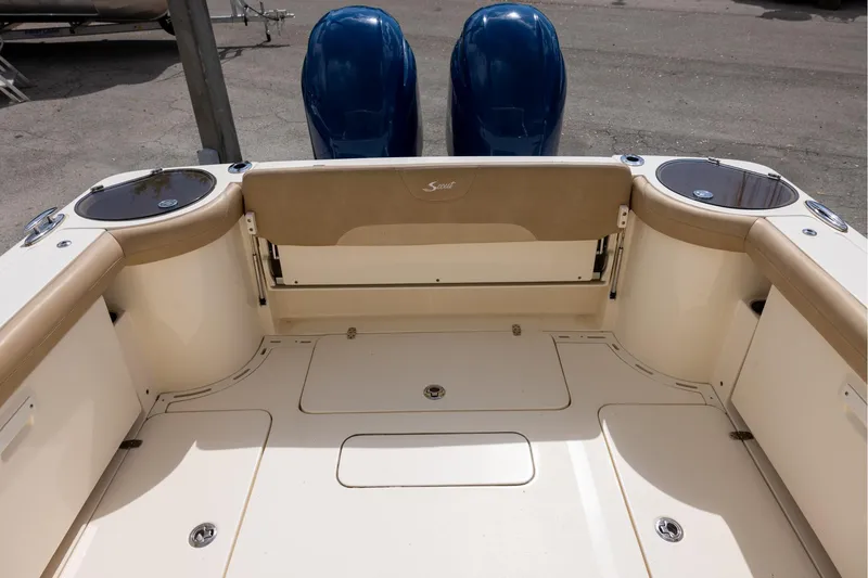 Slide: The Image of 2018 Scout 275 Dorado boat interior with dual engines and seating area. - 6