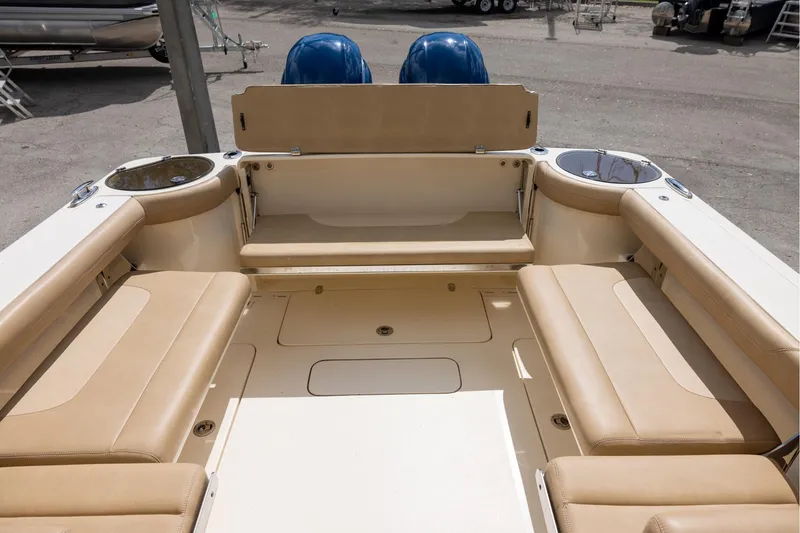Slide: The Image of 2018 Scout 275 Dorado boat interior with beige seating and cup holders. - 7