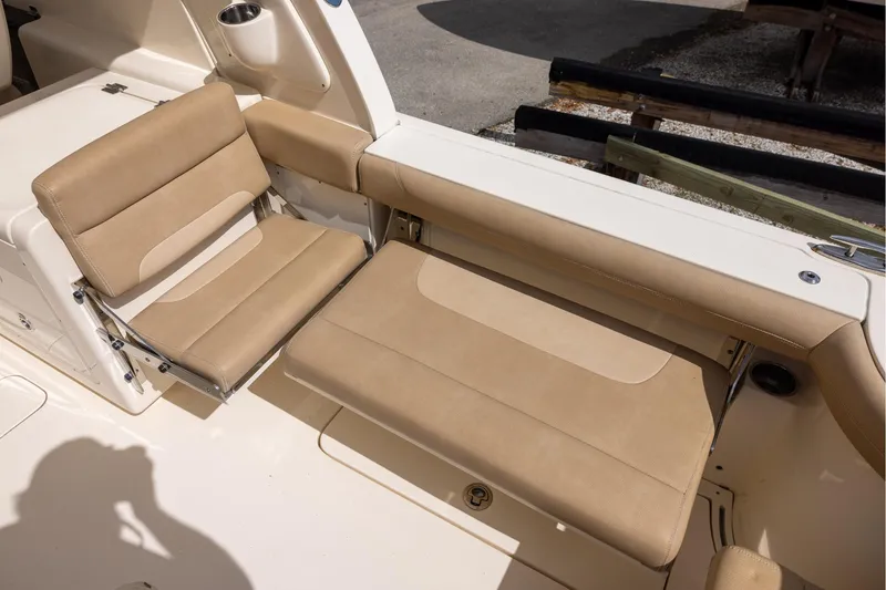 Slide: The Image of 2018 Scout 275 Dorado boat with beige seating and cup holder. - 8