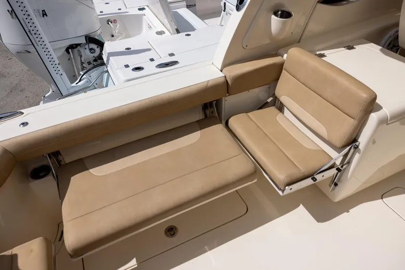 Slide: The Image of 2018 Scout 275 Dorado boat interior with beige seating and Yamaha engine. - 9