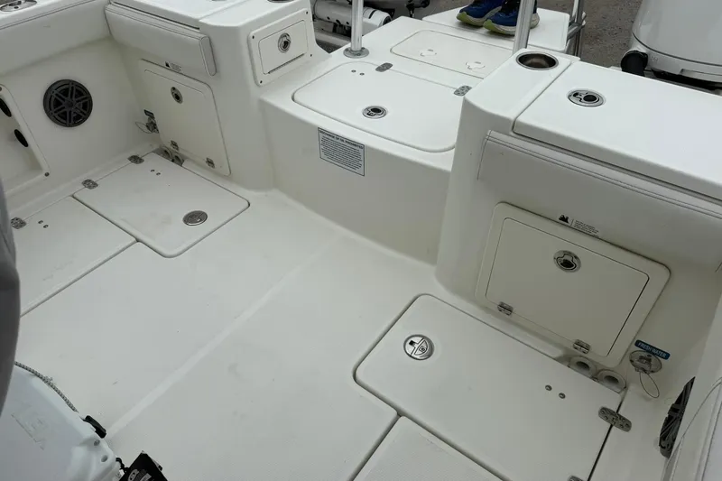 Slide: The Image of 2025 World Cat 235 TE boat interior with storage compartments and speaker. - 10