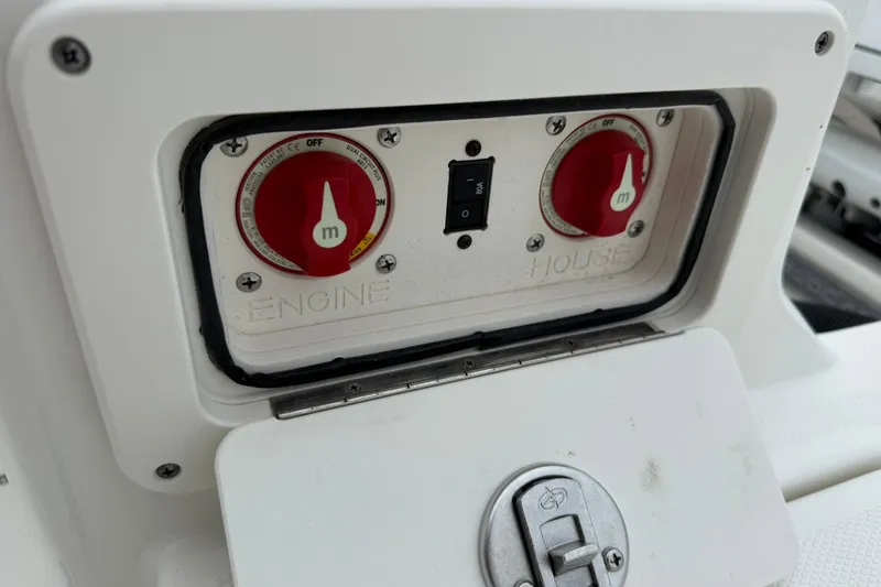 Slide: The Image of Control panel of a 2025 World Cat 235 TE boat with engine switches. - 11