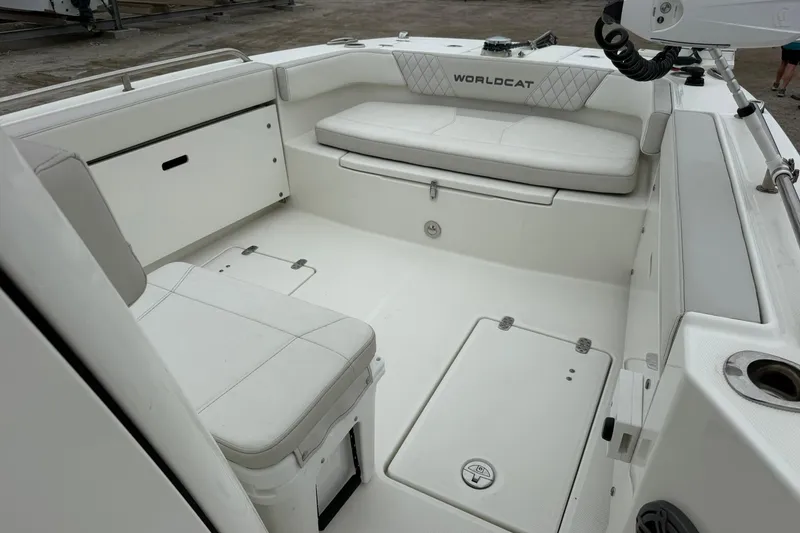 Slide: The Image of Interior of 2025 World Cat 235 TE boat with white seating and storage compartments. - 15
