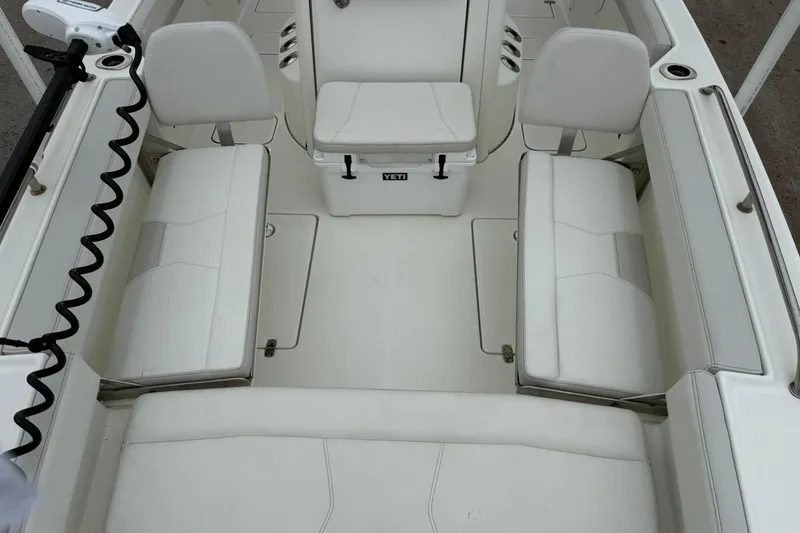 Slide: The Image of Interior view of 2025 World Cat 235 TE boat with white seating and spacious layout. - 16