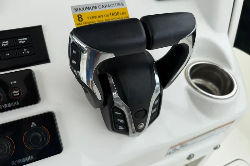 Slide: The Image of Boat control panel of 2025 World Cat 235 TE with Yamaha throttle and capacity label. - 19