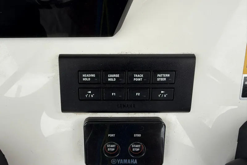 Slide: The Image of Control panel of 2025 World Cat 235 TE boat with Yamaha navigation buttons. - 20