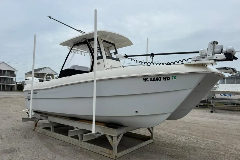 Slide: The Image of 2025 World Cat 235 TE boat on trailer, parked outdoors. - 5