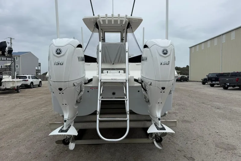 Slide: The Image of 2025 World Cat 235 TE boat with dual Yamaha 150 engines, parked outdoors. - 8