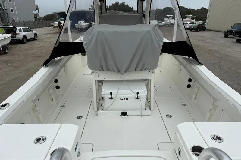 Slide: The Image of 2025 World Cat 235 TE boat interior with covered seating and Yeti cooler. - 9