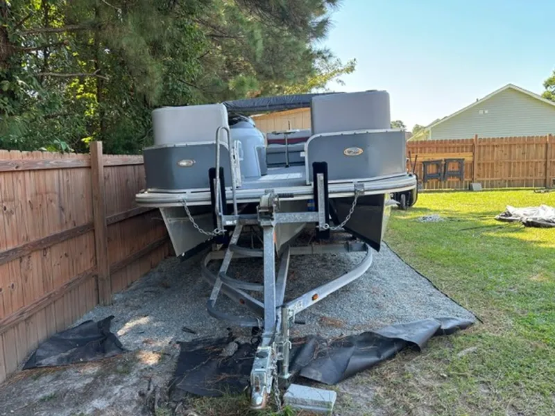 Slide: The Image of 2011 G3 SunCatcher pontoon boat on trailer in backyard. - 10