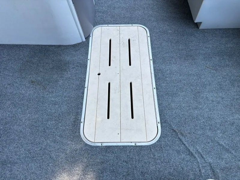 Slide: The Image of G3 SunCatcher 2011 boat hatch on gray carpet flooring. - 13