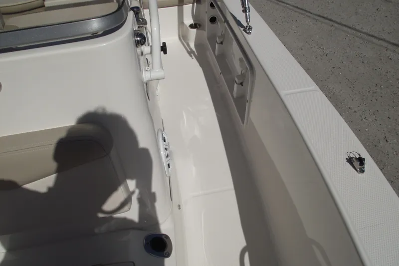 Slide: The Image of 2017 Robalo R160 Center Console boat interior with seating and storage compartments. - 10