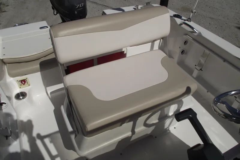 Slide: The Image of 2017 Robalo R160 Center Console boat interior with beige seating and steering wheel. - 13