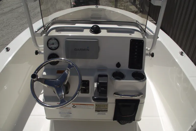 Slide: The Image of 2017 Robalo R160 Center Console boat dashboard with Garmin navigation system and steering wheel. - 14