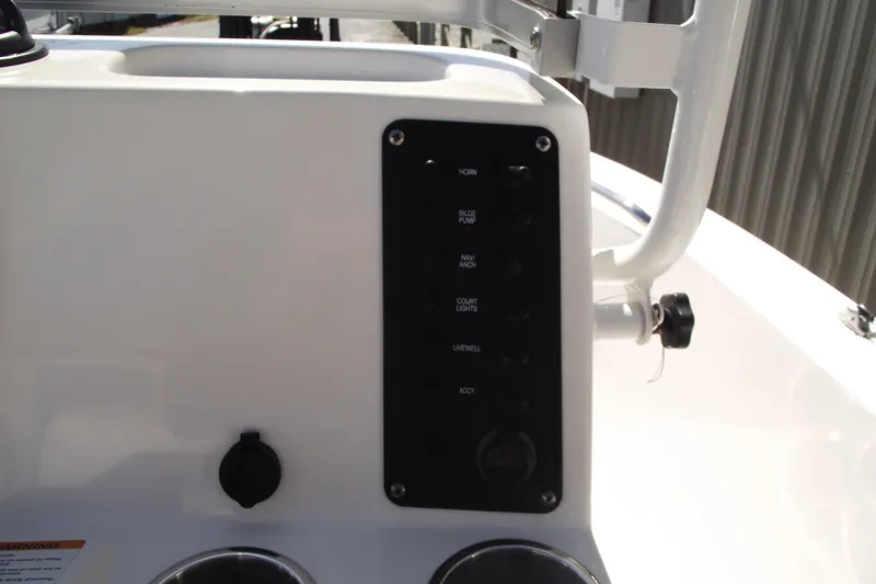 Slide: The Image of 2017 Robalo R160 Center Console boat control panel with switches and cup holders. - 15