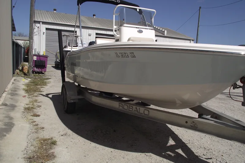 Slide: The Image of 2017 Robalo R160 Center Console boat on trailer in outdoor setting. - 2