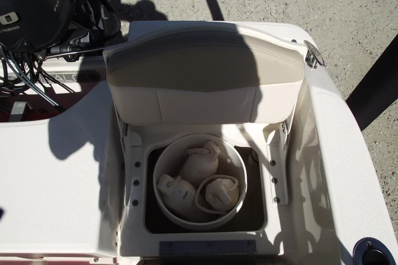 Slide: The Image of 2017 Robalo R160 Center Console boat seat storage with bucket and items inside. - 21