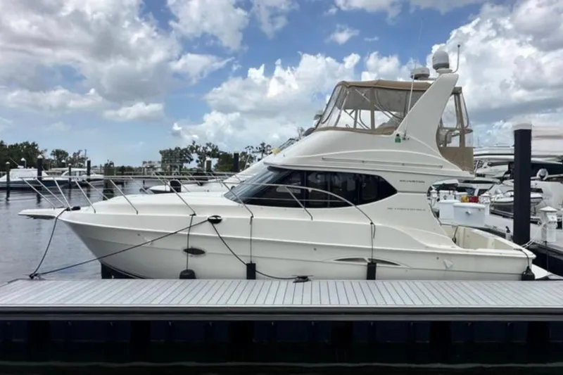 The Image of 2008 Silverton 36 Convertible yacht docked at marina under cloudy sky. - 0