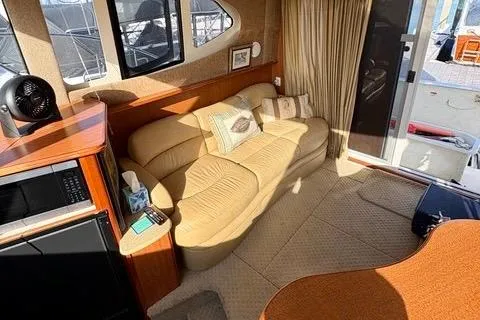 Slide: The Image of Interior of 2008 Silverton 36 Convertible yacht with beige sofa and wooden cabinetry. - 18