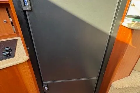 Slide: The Image of Black refrigerator door inside a 2008 Silverton 36 Convertible yacht kitchen. - 23