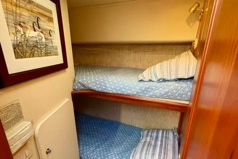 Slide: The Image of Bunk beds in 2008 Silverton 36 Convertible yacht cabin with framed artwork. - 28