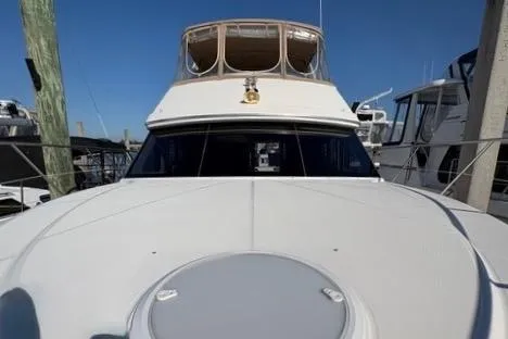 Slide: The Image of 2008 Silverton 36 Convertible yacht docked at marina under clear blue sky. - 3