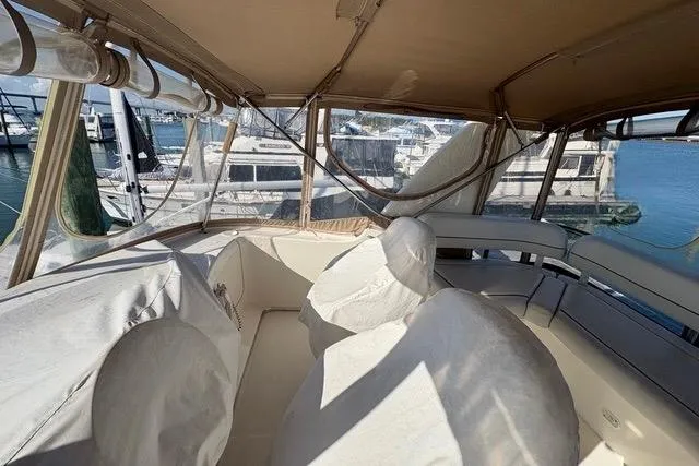 Slide: The Image of 2008 Silverton 36 Convertible boat interior with covered seating and marina view. - 5