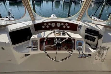 Slide: The Image of 2008 Silverton 36 Convertible yacht helm with steering wheel and control panel. - 9