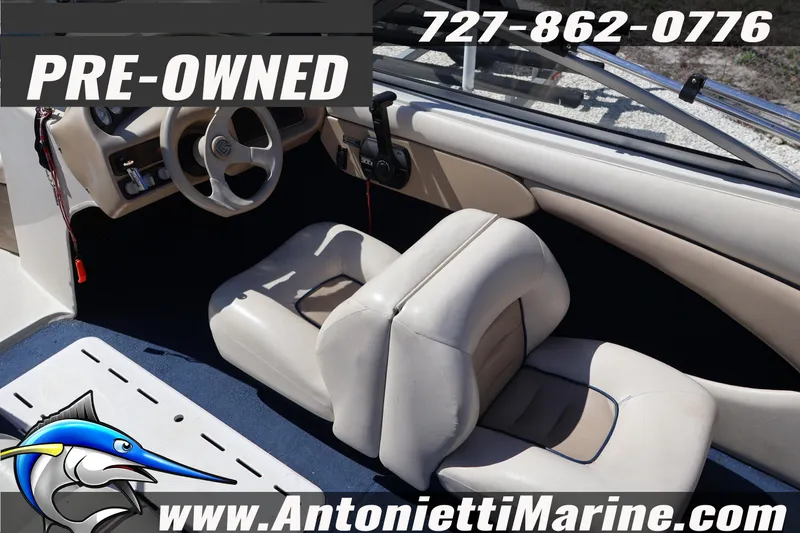 Slide: The Image of Pre-owned 1997 Glastron boat interior with steering wheel and seating, available at Antonietti Marine. - 10