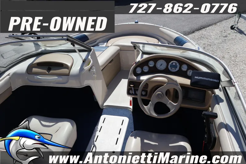 Slide: The Image of Pre-owned 1997 Glastron boat interior with steering wheel and dashboard, Antonietti Marine. - 12