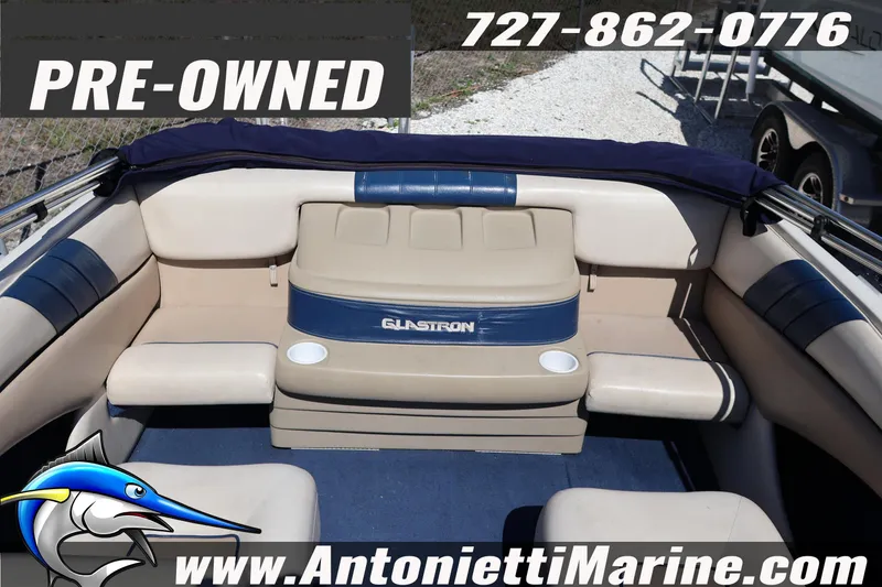 Slide: The Image of Pre-owned 1997 Glastron boat interior with beige and blue seating, available at Antonietti Marine. - 9