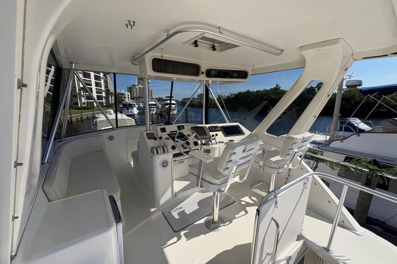 Slide: The Image of Cockpit of 1996 Ocean Yachts 48 Super Sport with helm and seating, docked at marina. - 3