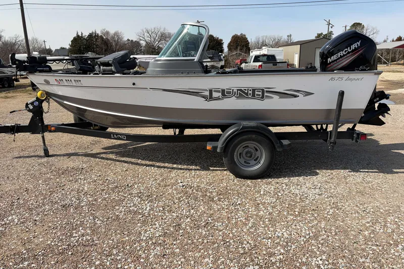 The Image of 2016 Lund 1675 Impact fishing boat on trailer with Mercury outboard motor. - 1