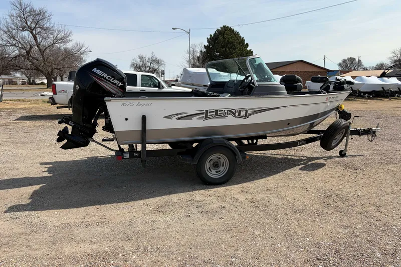Slide: The Image of 2016 Lund 1675 Impact boat on trailer with Mercury outboard motor. - 3