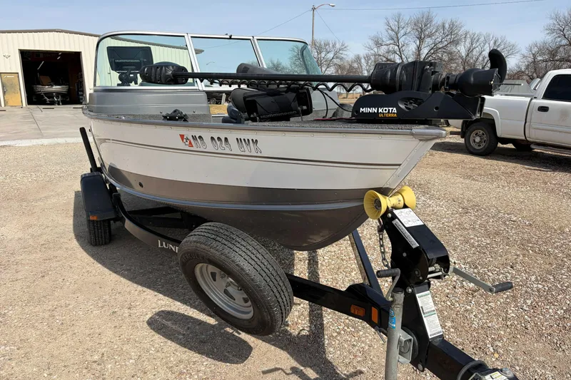 Slide: The Image of 2016 Lund 1675 Impact boat on trailer with Minn Kota motor in outdoor setting. - 4