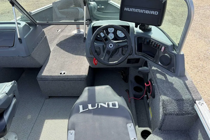 Slide: The Image of 2016 Lund 1675 Impact boat interior with steering wheel and Humminbird display. - 5