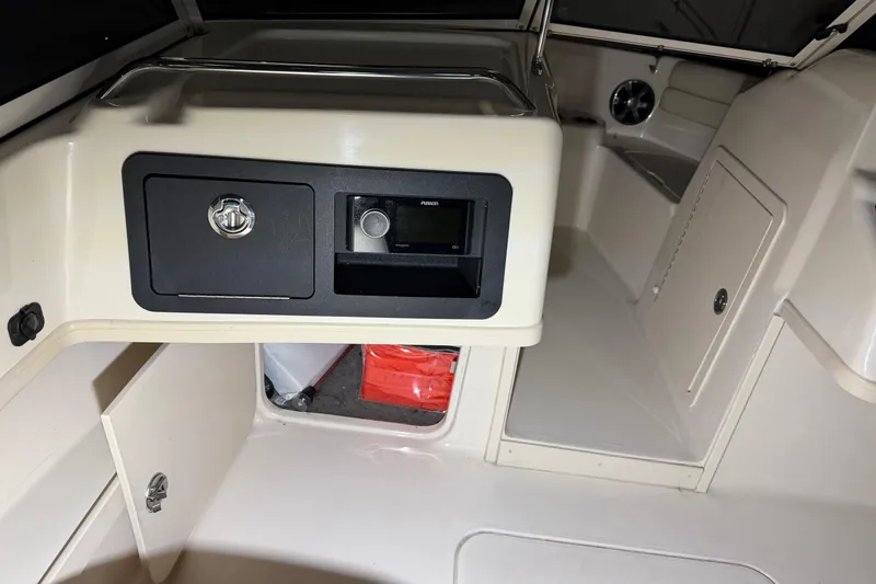 Slide: The Image of 2020 Grady White Freedom 192 boat interior with storage compartments and audio system. - 10