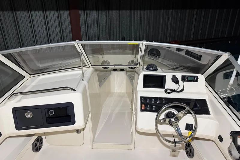 Slide: The Image of 2020 Grady White Freedom 192 boat dashboard with steering wheel and control panel. - 12