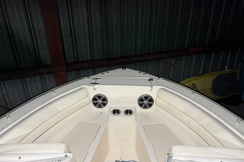 Slide: The Image of 2020 Grady White Freedom 192 boat interior with seating and speakers in a storage area. - 13