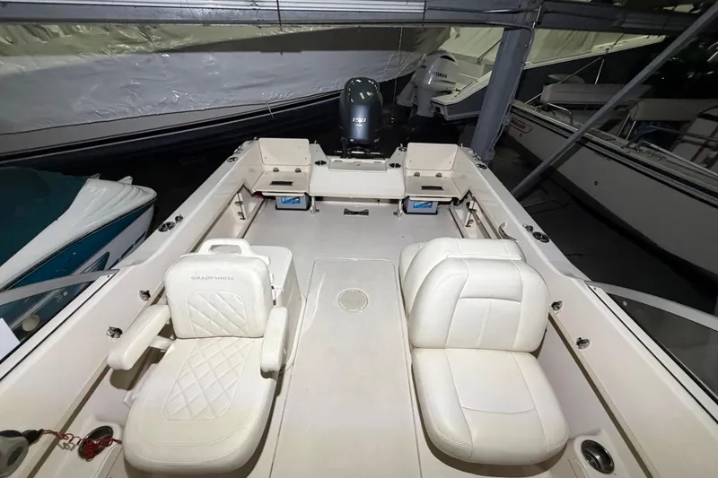 Slide: The Image of 2020 Grady White Freedom 192 boat interior with white seating and Yamaha outboard motor. - 6