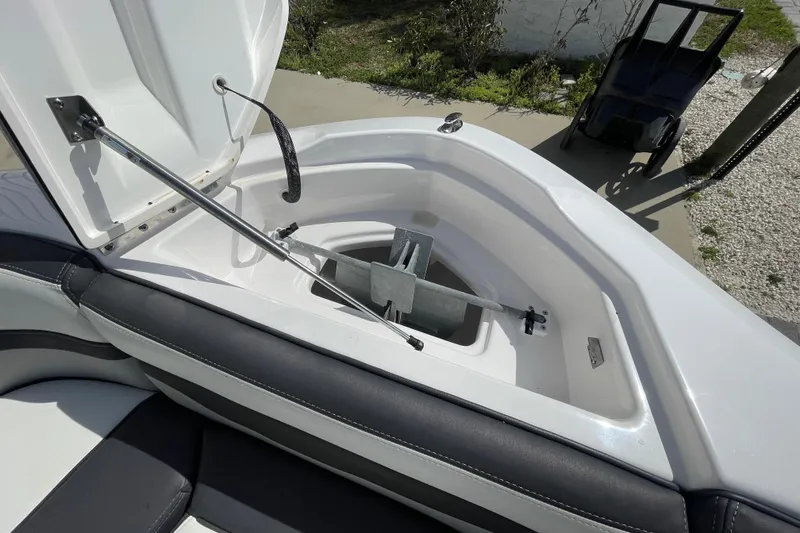 Slide: The Image of Open anchor compartment on 2021 Yamaha Boats 275SE, showcasing storage and mechanism. - 20