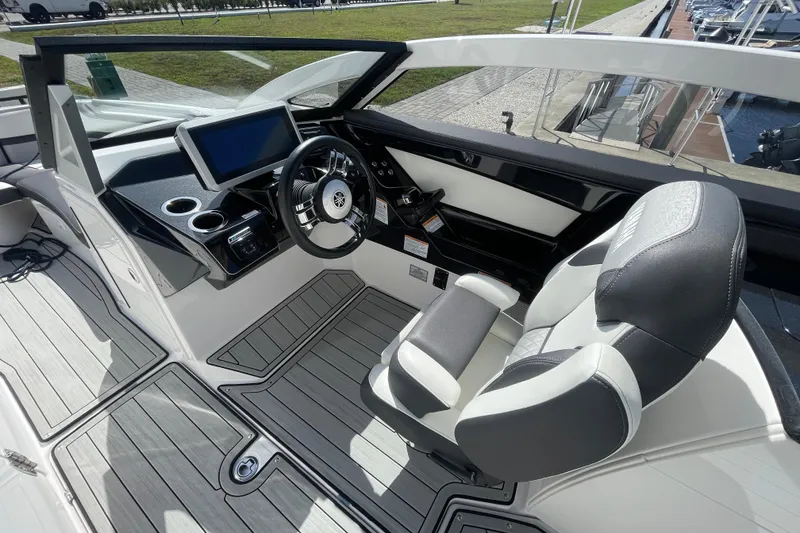 Slide: The Image of 2021 Yamaha Boats 275SE cockpit with modern steering and touchscreen display. - 9