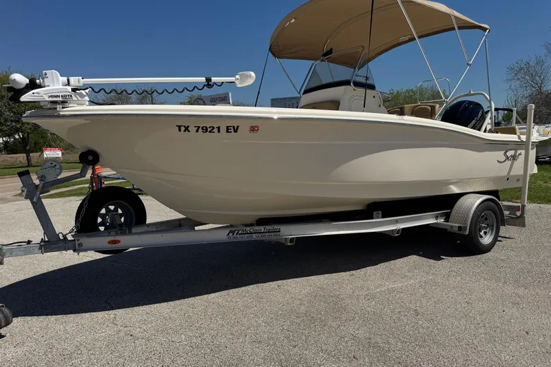Slide: The Image of 2018 Scout 195 Sportfish boat on trailer with canopy and Minn Kota motor. - 11