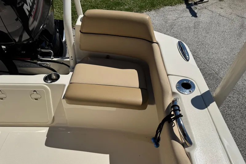 Slide: The Image of 2018 Scout 195 Sportfish boat interior with tan seating and cup holder. - 13