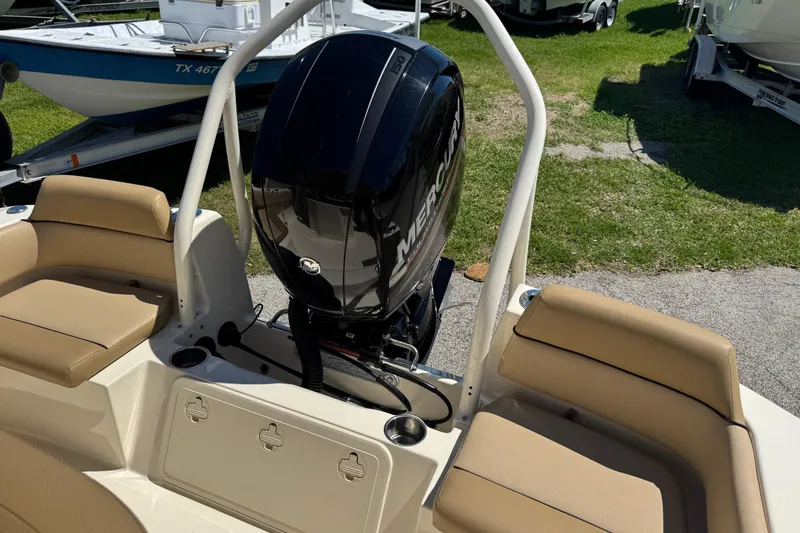 Slide: The Image of 2018 Scout 195 Sportfish boat with Mercury outboard motor and beige seating. - 14