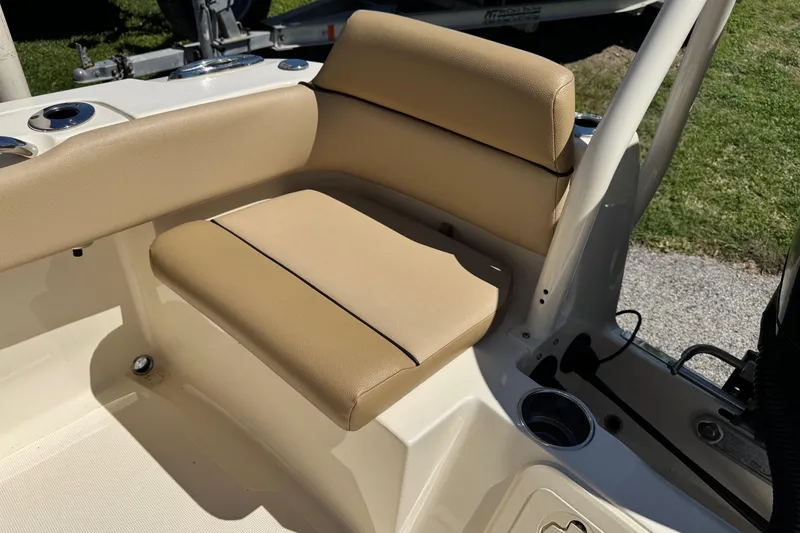 Slide: The Image of 2018 Scout 195 Sportfish boat seat with beige upholstery and cup holders. - 15